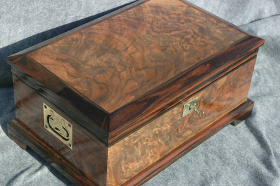 walnut burl keepsake box with ebony trim handles and lock